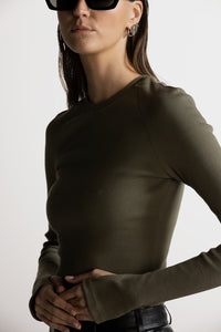 PIXIE WON'T PLAY TRINITY LONG - SLEEVE TOP RIBBED KHAKI GREEN ORGANIC COTTON SUSTAINABLE FASHION WEAR WITHOUT BRA LUXURY STYLISH COMFORTABLE BREATHABLE FABRIC VERSATILE RELAXED FIT SOFT TRENDY SUMMER AUTUMN WINTER SPRING WEAR CASUAL OUTFIT WORKOUT LAYERING VARIOUS COLORS FASHIONABLE MUST-HAVE EVERYDAY ESSENTIALS